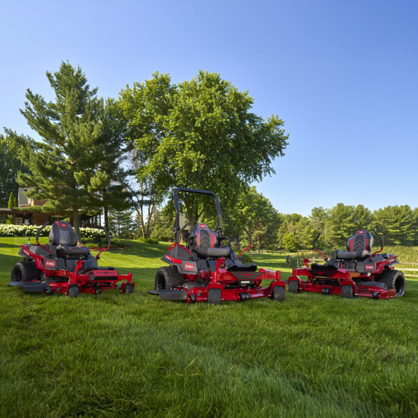 A lineup of red and black Toro zero-turn mowers on a lawn