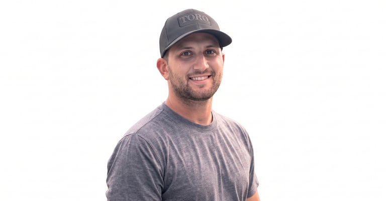 Matt Gerardy, owner of Gerardy Outdoor Power, smiling in a Toro cap